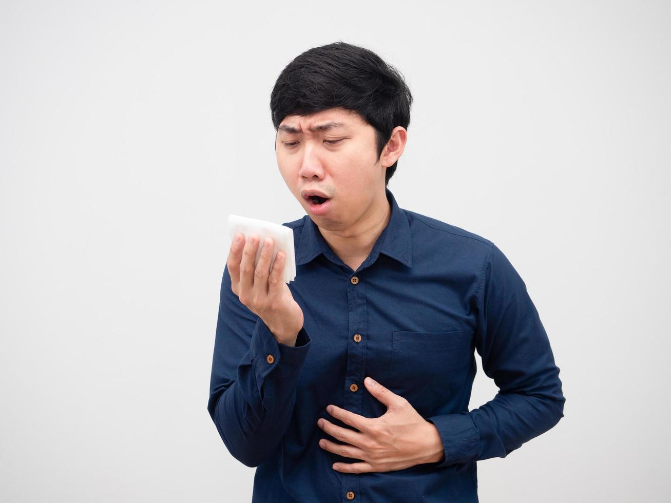 Asian man feeling sick and couch holding tissue paper unwell face white background photo