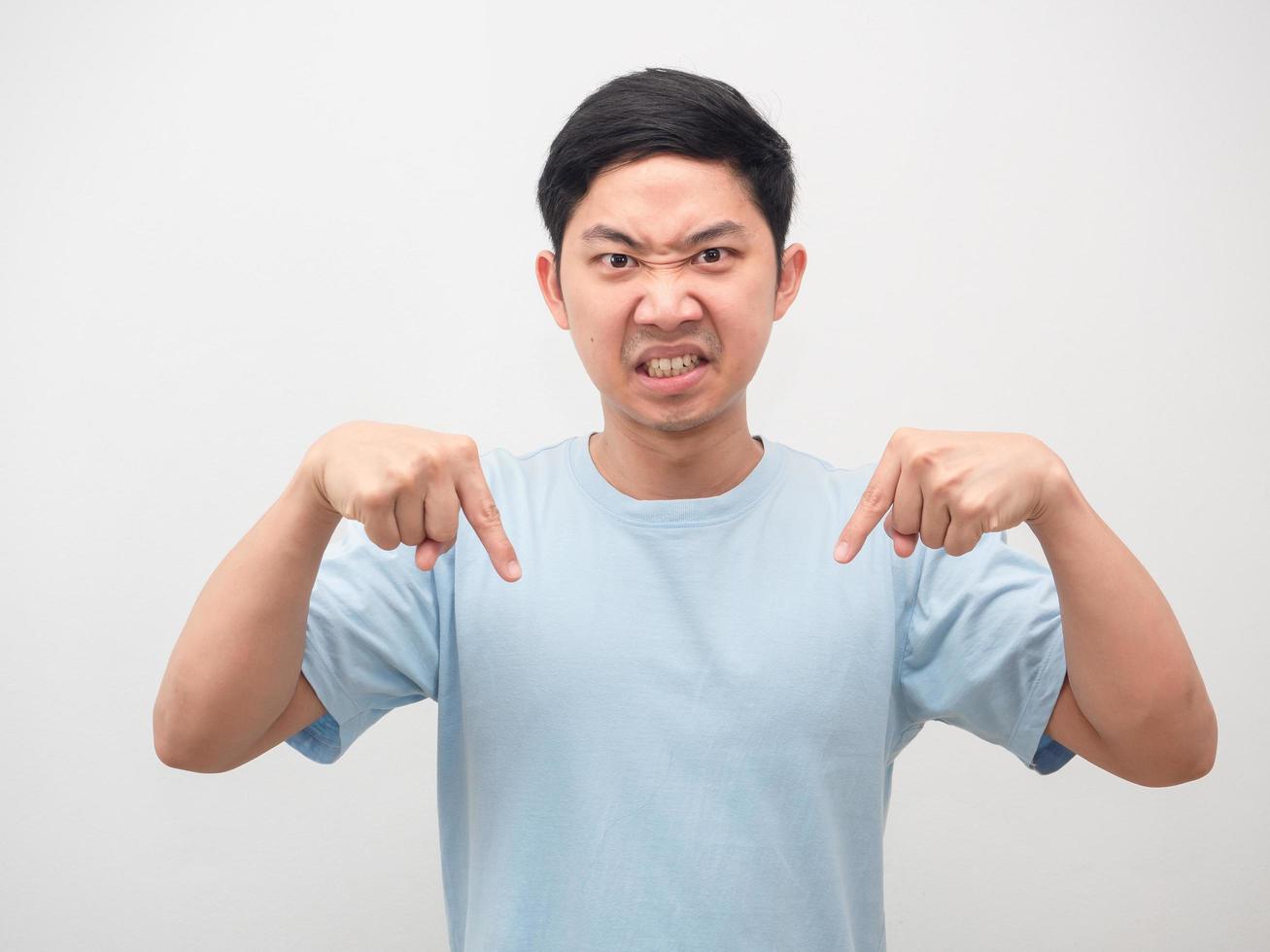 Man angry face looking and point finger down white background photo