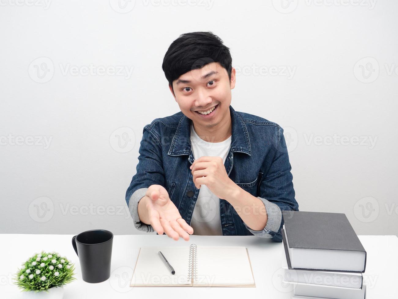 Cheerful man smiling sit at the workplace desk gesture recommend photo