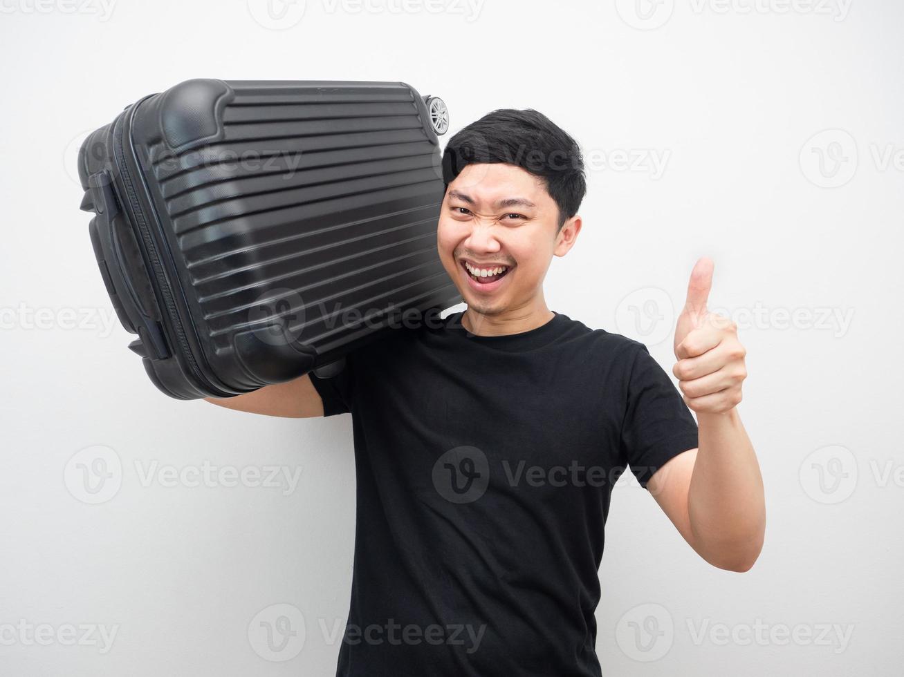 Man gesture carry luggage with smiling and thumb up photo