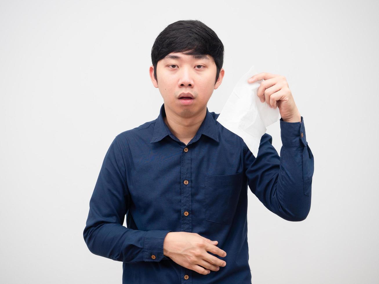 Asian man sick unwell face holding tissue paper in hand on white background photo