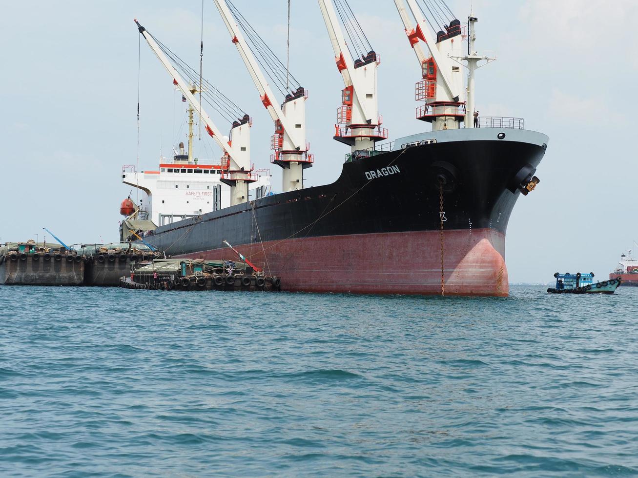 Industrial ship with big crane logistic boat in the ocean and blue sky,Transportation industrial ship concept photo