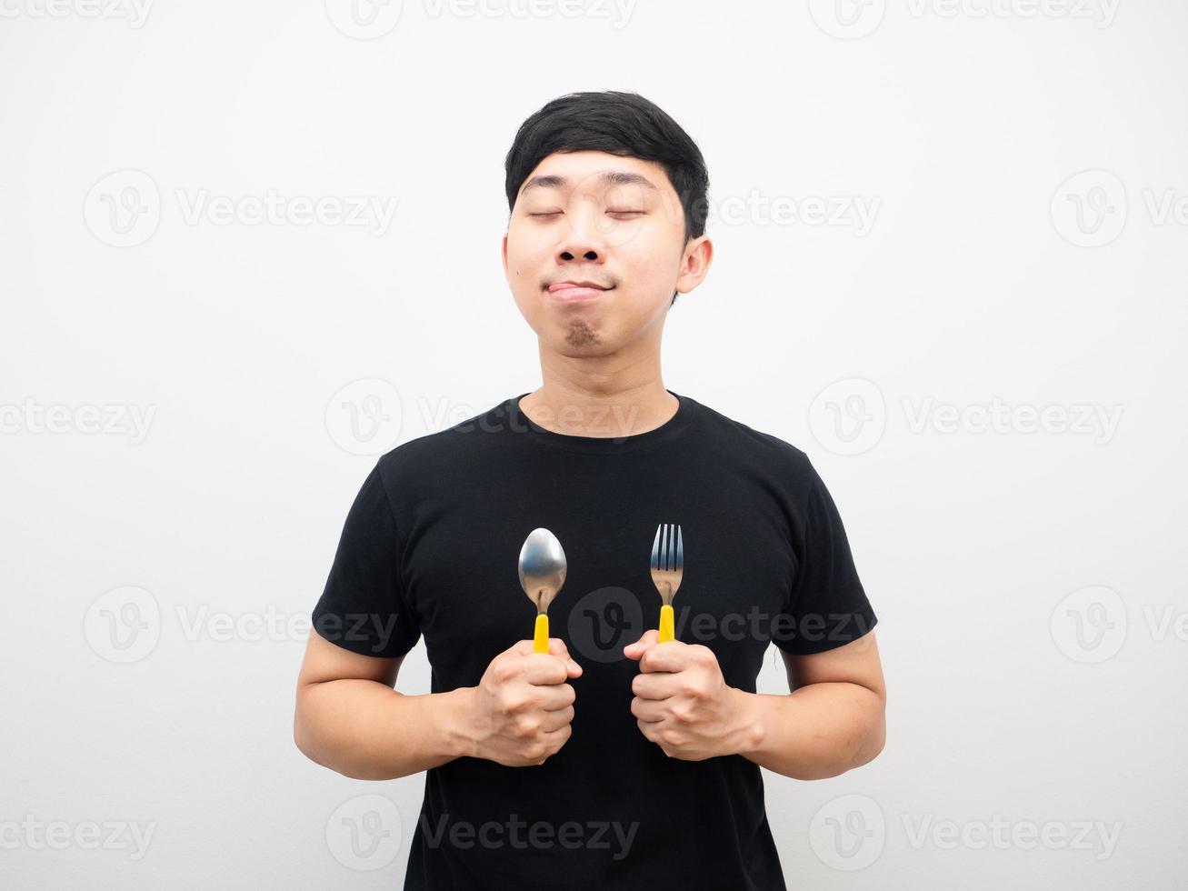 Hungry man holding spoon dreaming about dinner photo