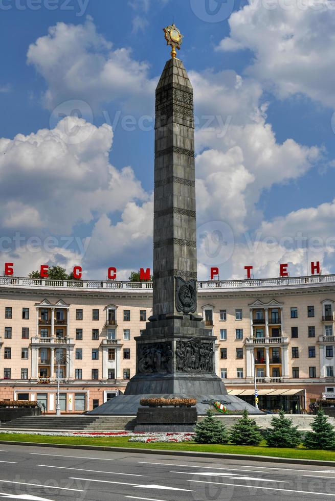 Monument in honor of the victory in World War II at Victory Square in Minsk, Belarus. Red letters read Heroic deed of the people is immortal. photo