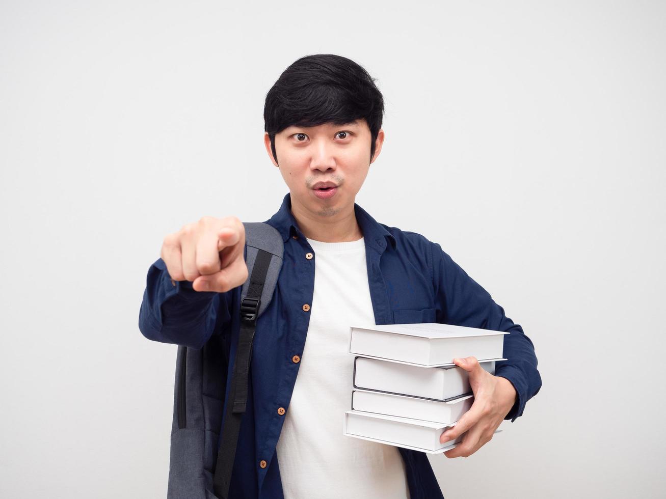 Asian man with school bag holding books point finger at you confident face white background photo