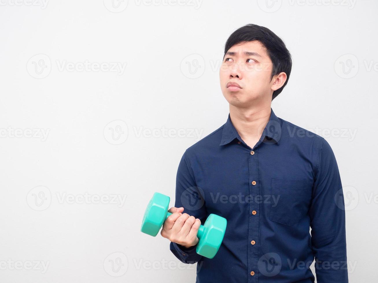Man lazy emotion holding dumbbell looking at copy space photo