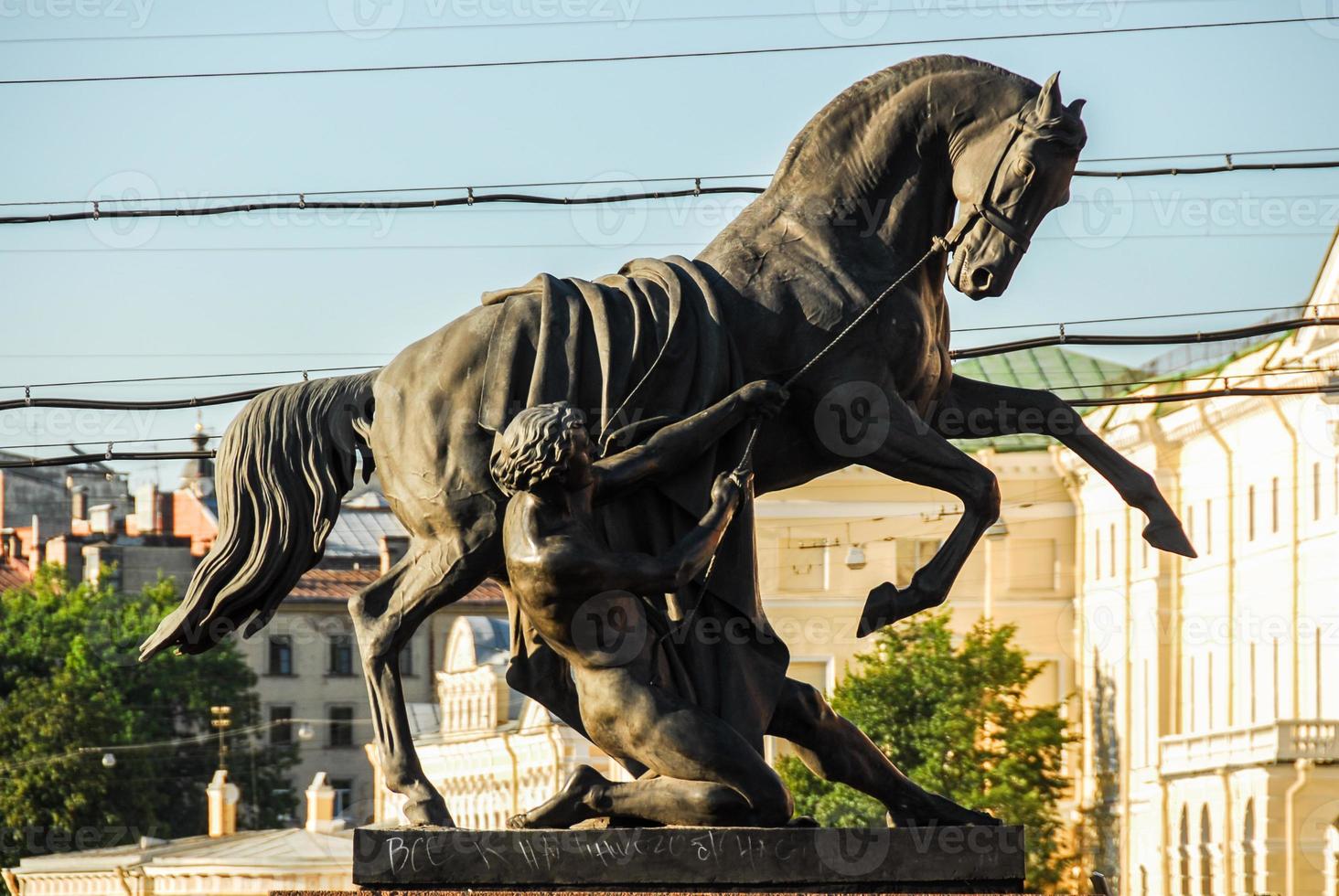 View of the Horse Tamers monument by Peter Klodt on the Anichkov Bridge in Saint Petersburg, Russia. photo