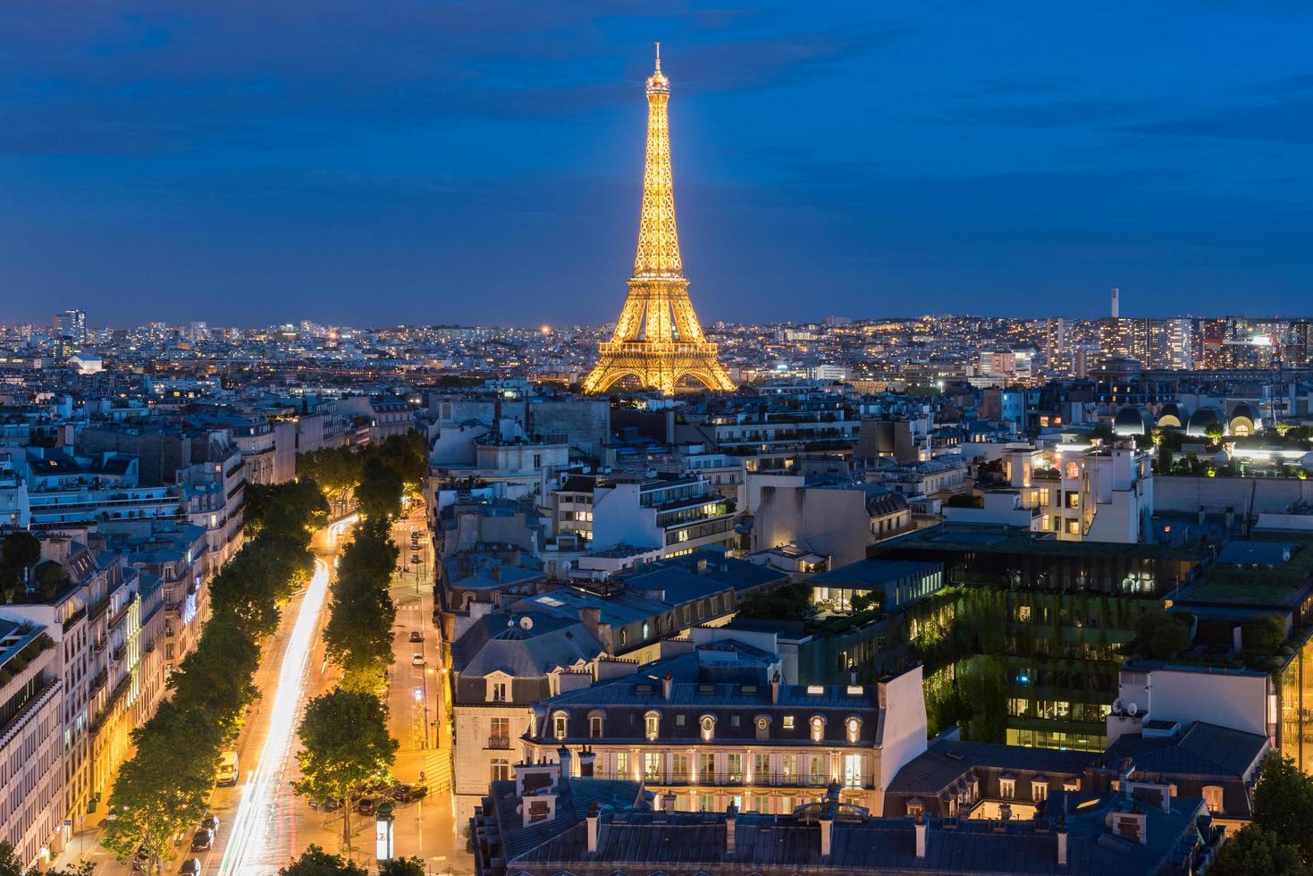 View of the the Eiffel Tower and the Paris city skyline into the distance at dusk, 2022 photo