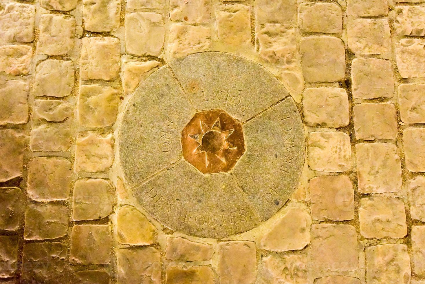 Point Zero, just outside of Notre Dame Cathedral embedded in the concrete of the public square is a small geographic marker from which the distance from Paris to all other places are judged. photo