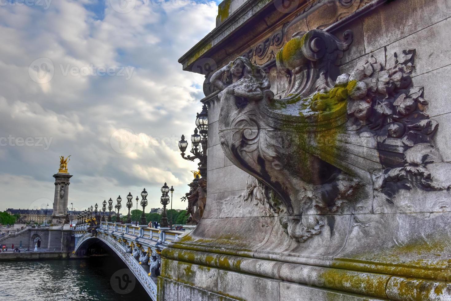 The Pont Alexandre III is a deck arch bridge that spans the Seine in Paris. It connects the Champs-Elysees quarter with those of the Invalides and Eiffel Tower. photo
