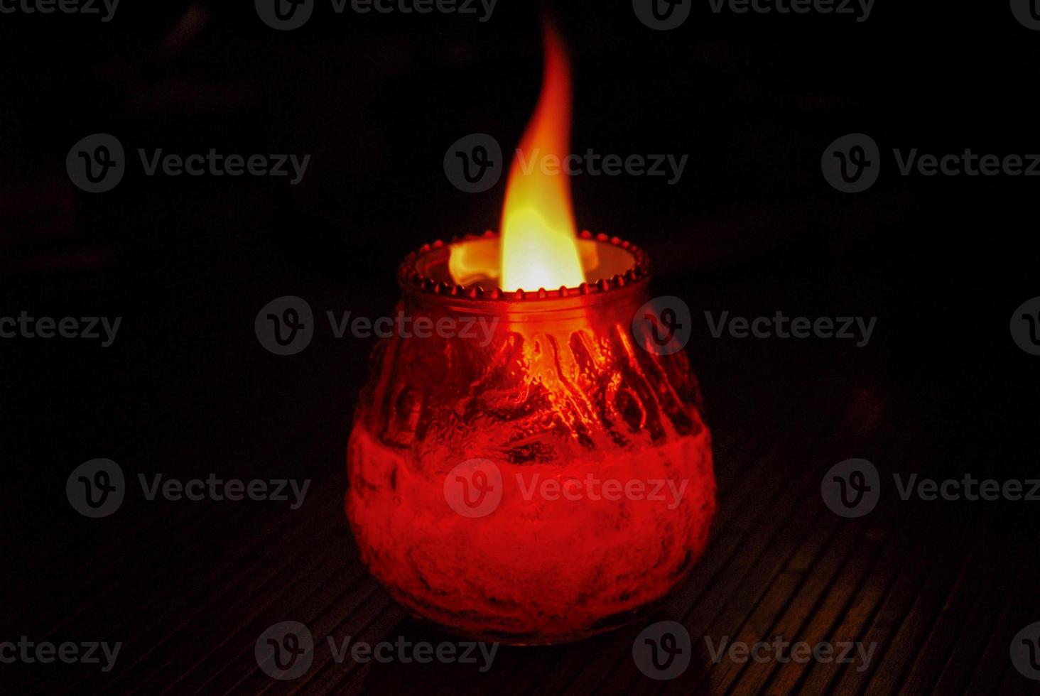 Flaming Candle in the dark photo