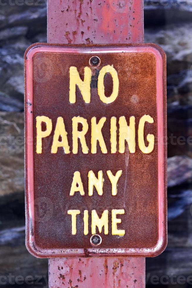 Old rusted No Parking Any Time street sign. photo