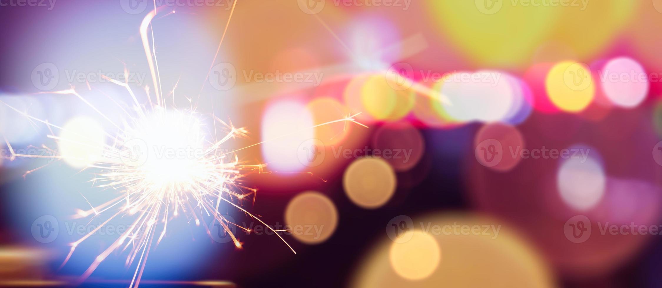 Happy New Year background with glowing sparklers. photo