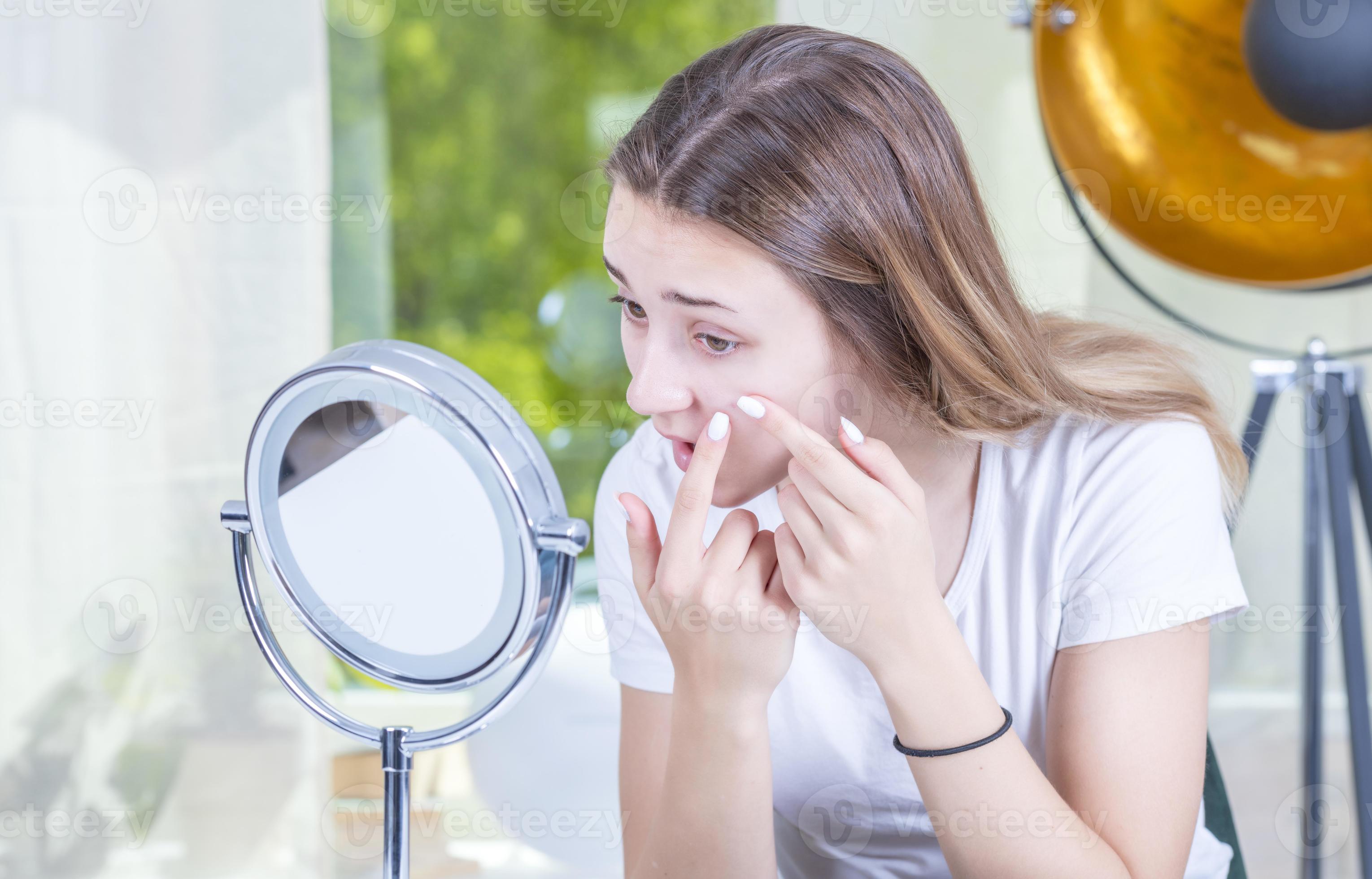checking problematic face skin at home. Young teenager with self issues