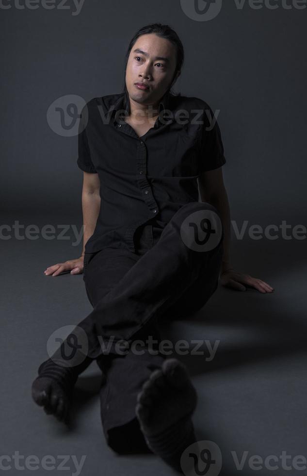 handsome asian fashion looking man posing in studio on black background, lifestyle modern people concept photo