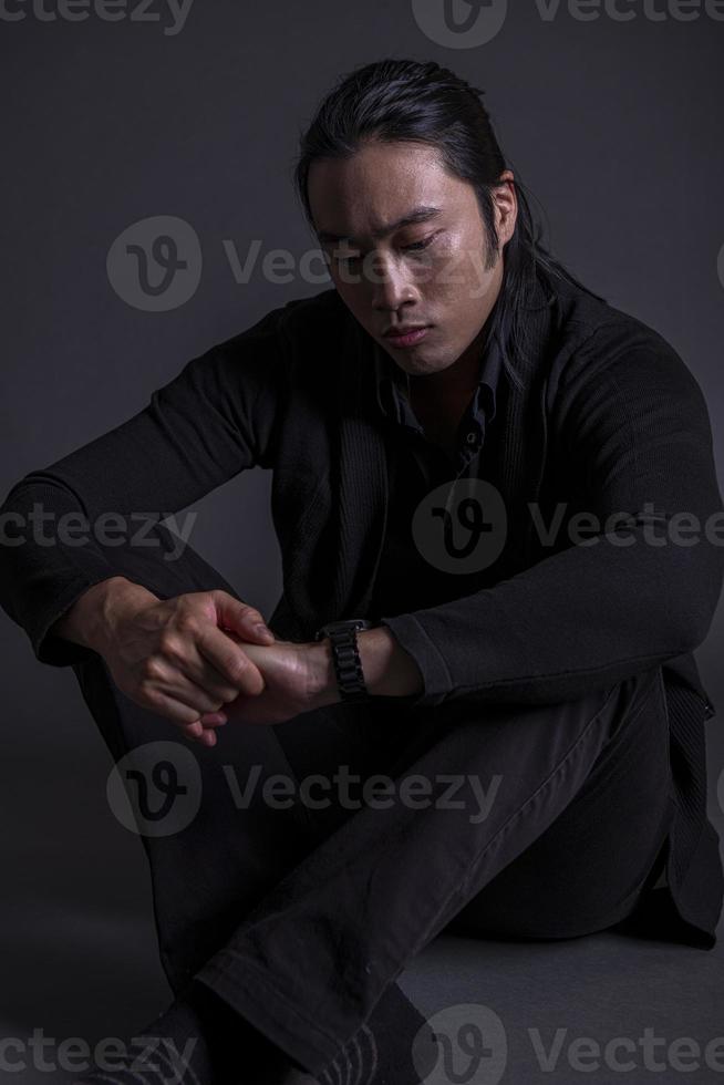 handsome asian fashion looking man posing in studio on black background, lifestyle modern people concept photo