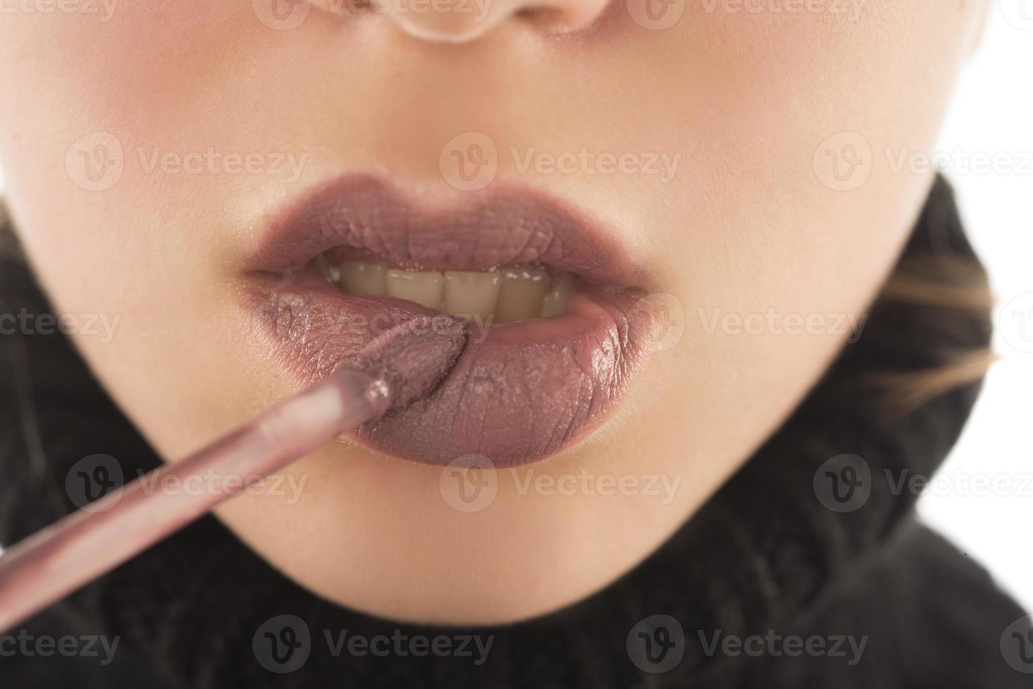 Makeup, lip makeup.Woman performs makeup, paints lips liner pencil photo