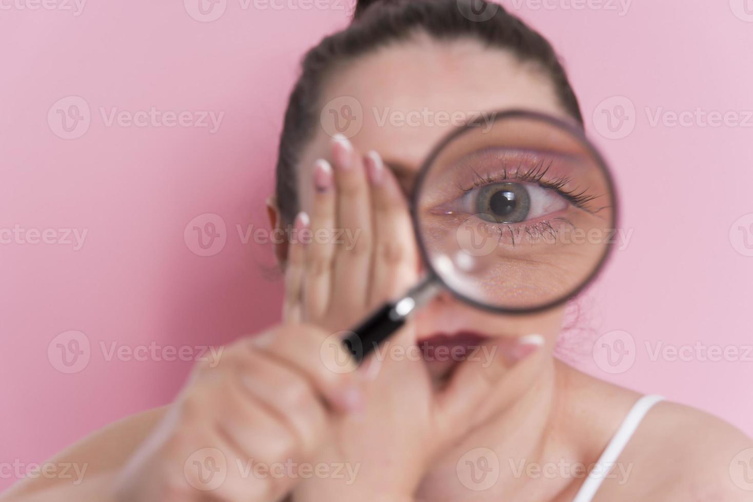 woman looking true magnifying glass photo