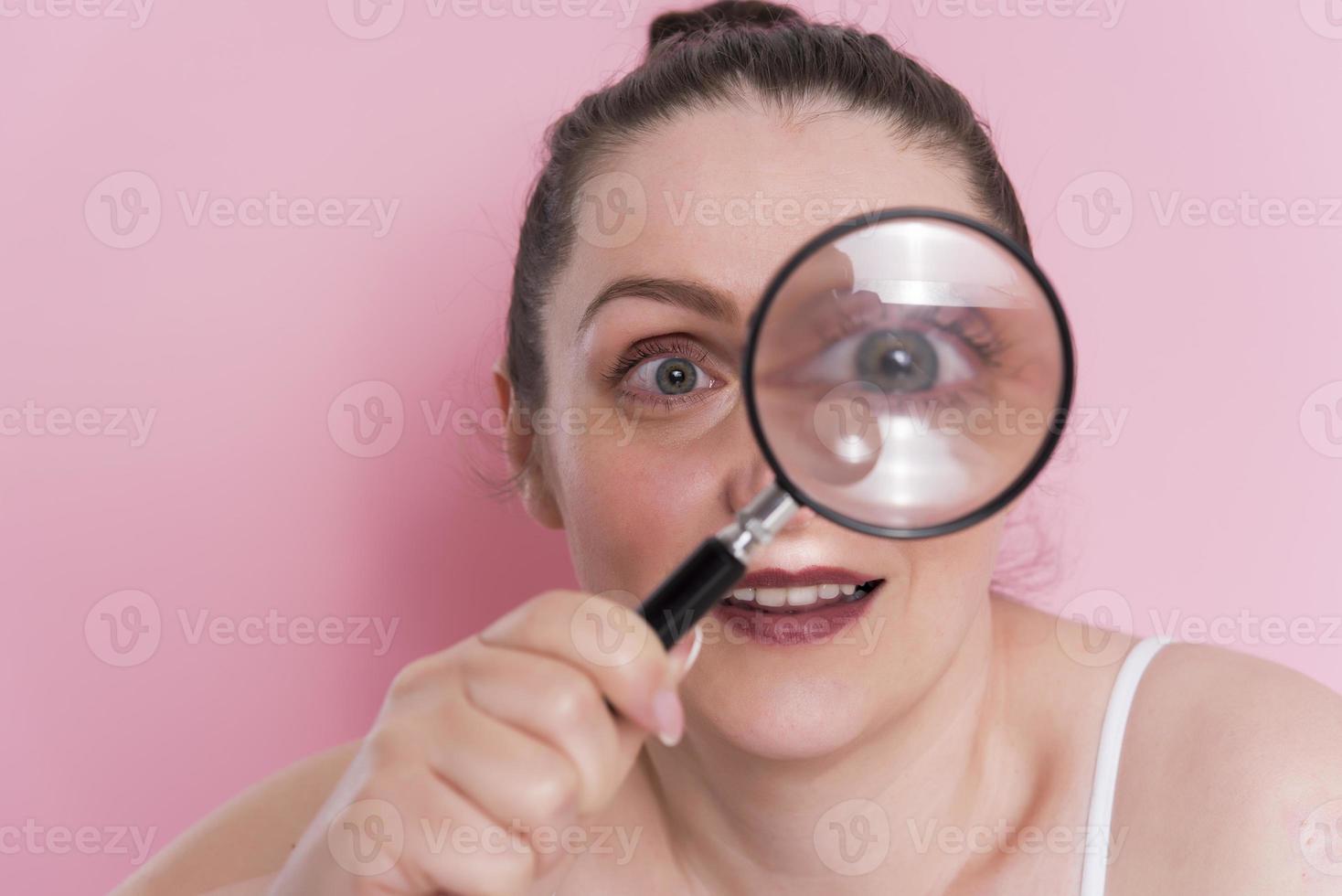 woman looking true magnifying glass photo