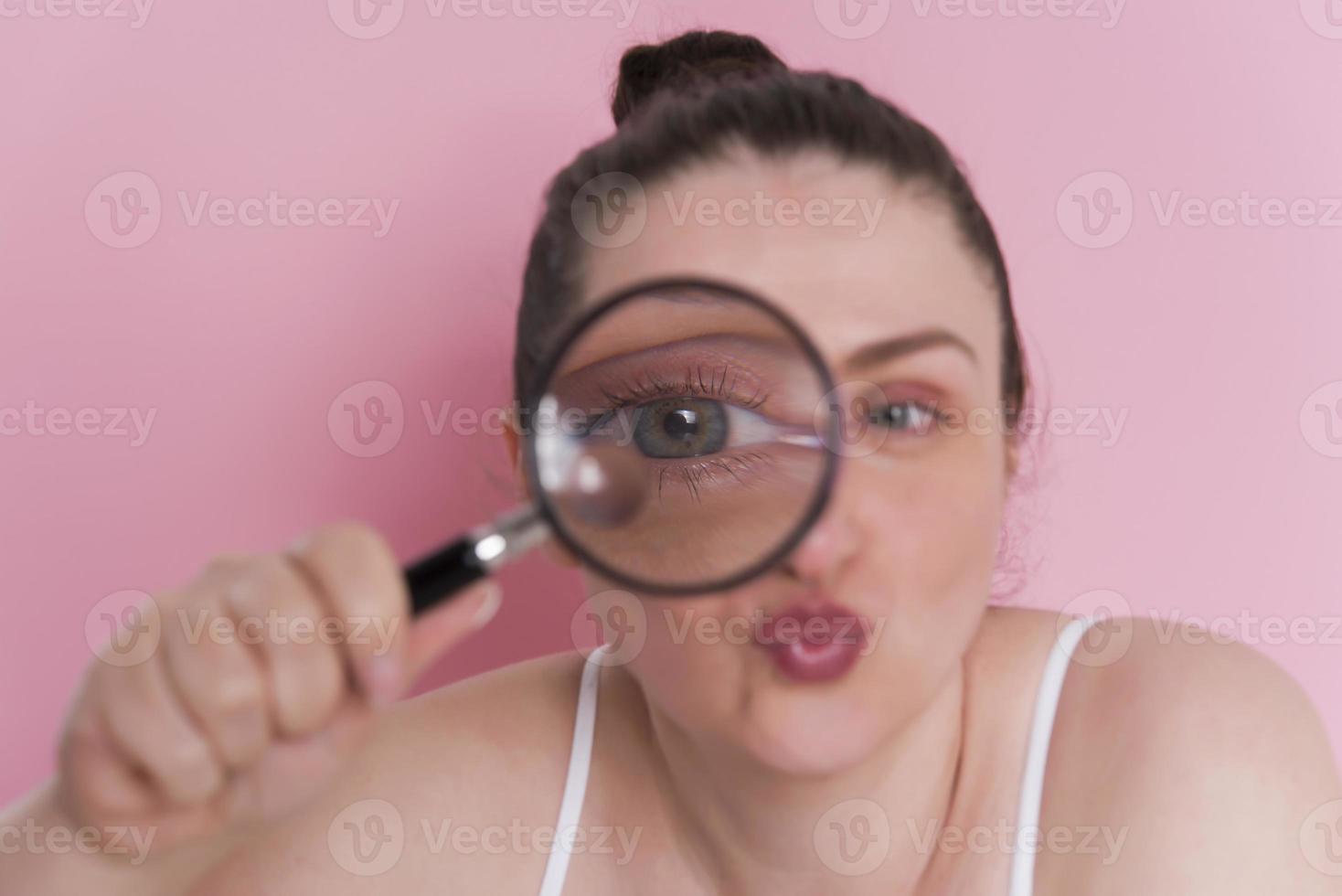 woman looking true magnifying glass photo