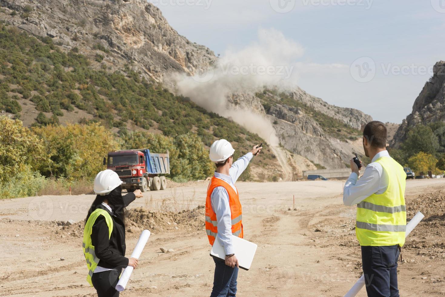 Surveyor engineer is measuring level on construction site. Surveyors ensure precise measurements before undertaking large construction projects. photo