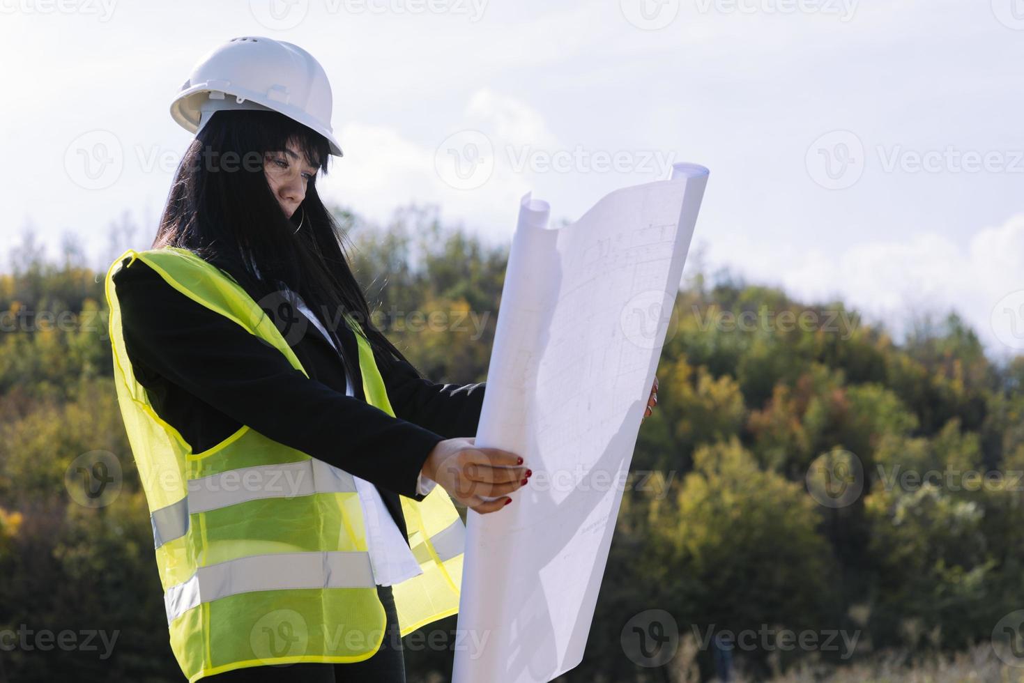 Surveyor engineer is measuring level on construction site. Surveyors ensure precise measurements before undertaking large construction projects. photo