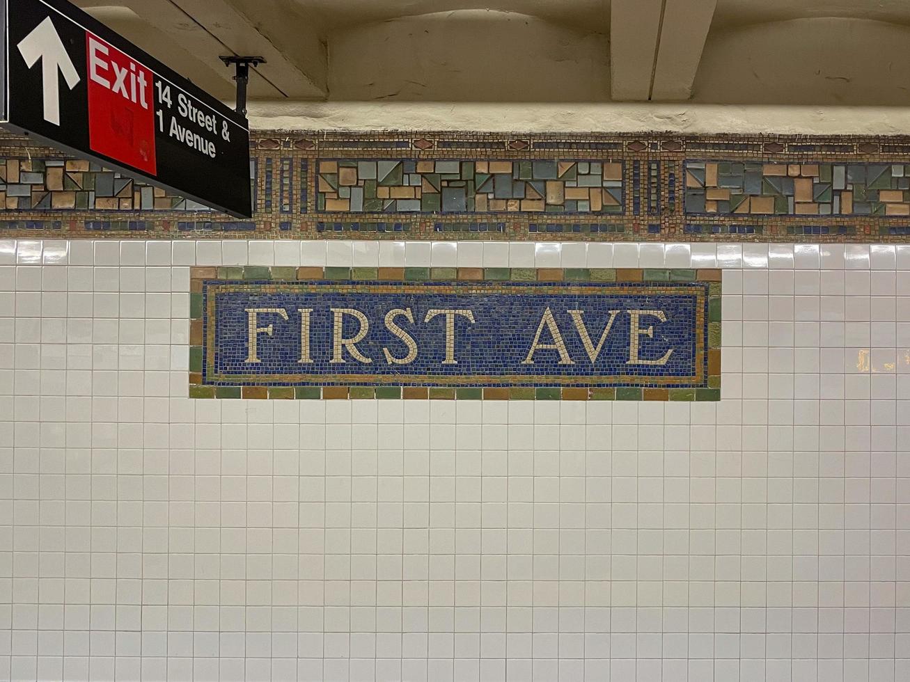 Brooklyn, New York - Apr 24, 2021 -  First Avenue Subway Station sign along 14th Street in Manhattan, New York City. photo