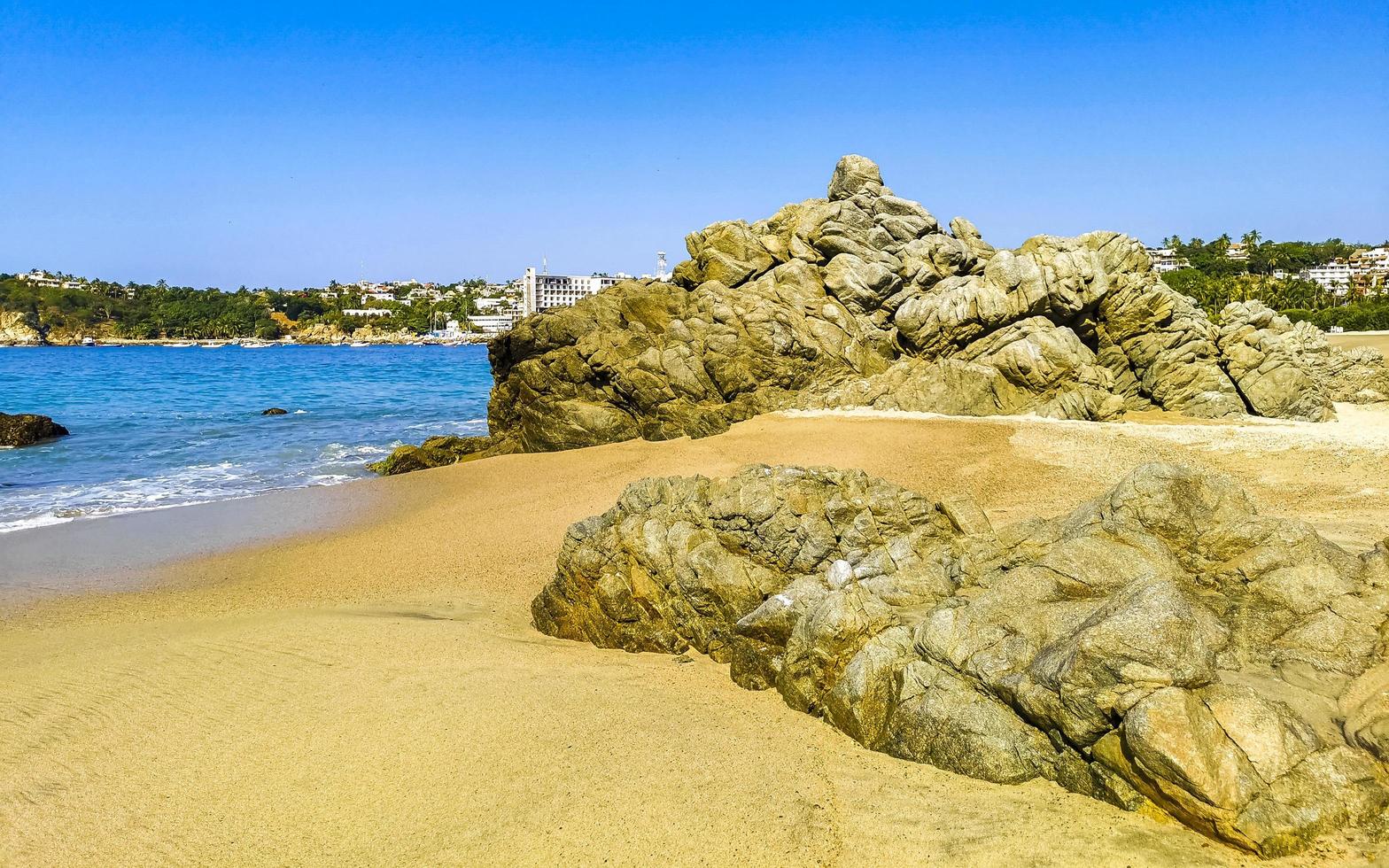 Big surfer waves and rocks at beach Puerto Escondido Mexico. photo