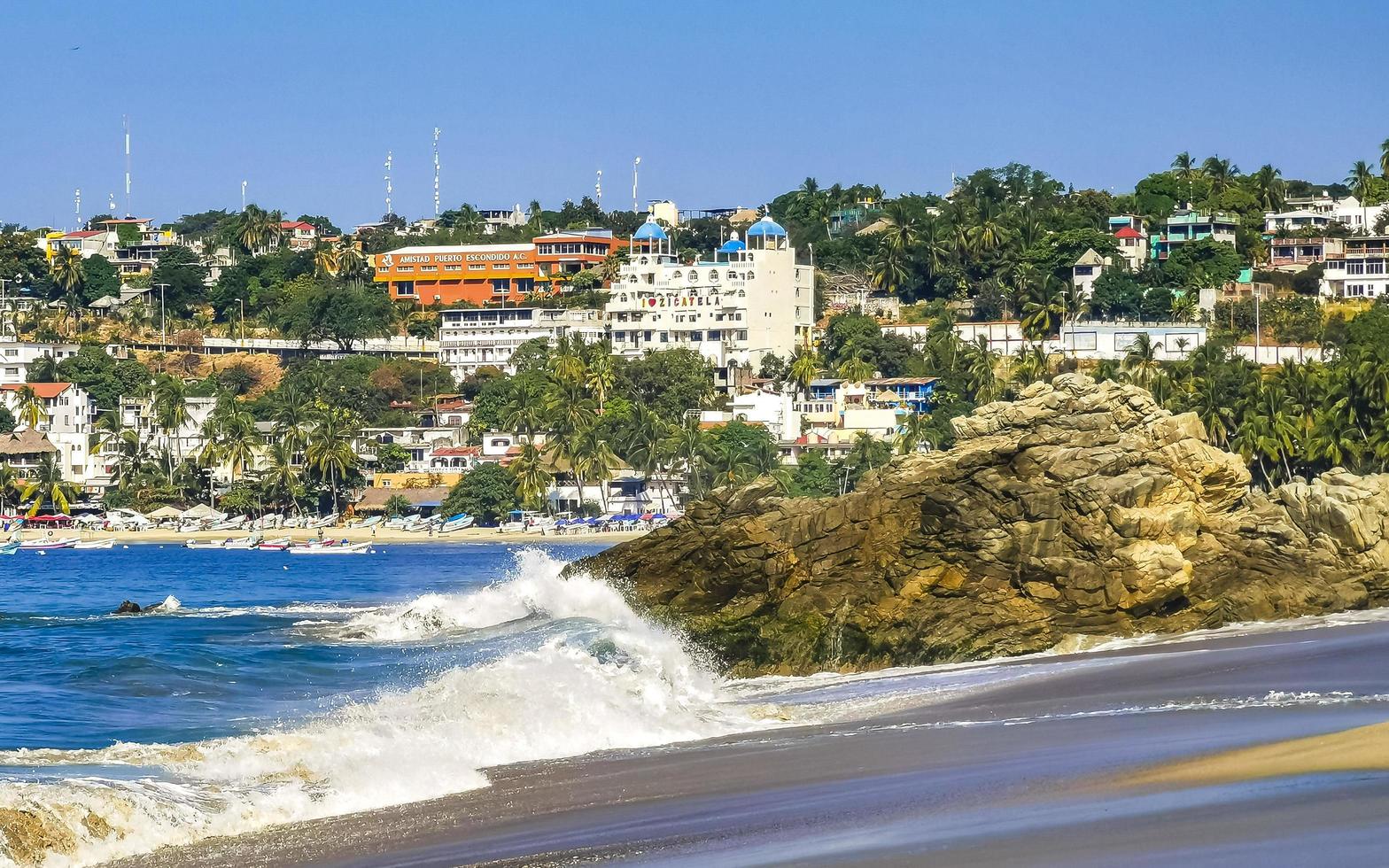 Puerto Escondido Oaxaca Mexico 2022 Big surfer waves and rocks at beach Puerto Escondido Mexico. photo