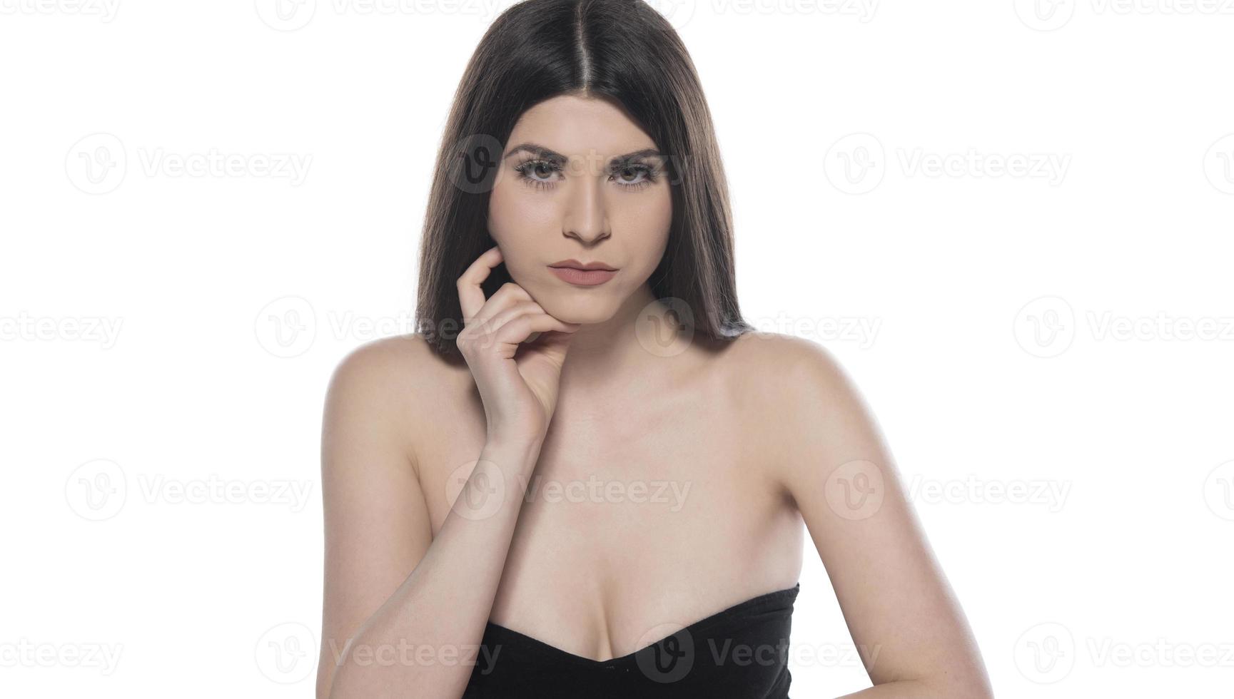 sensual woman with beautiful black shiny hair and beautiful skin posing in studio on white background photo