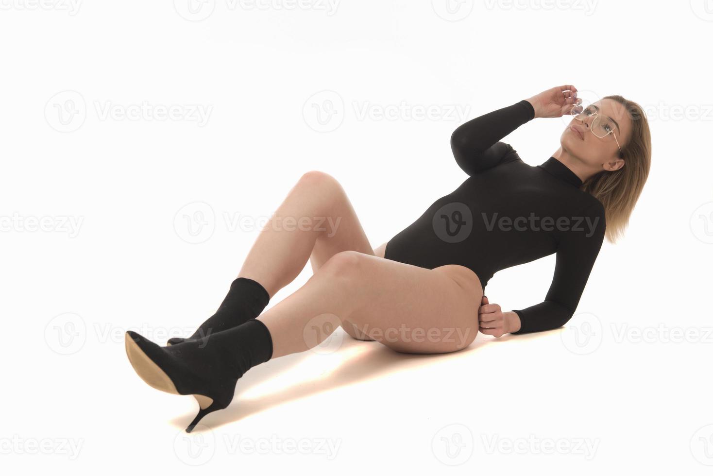 Fashionable young attractive woman posing in studio, wearing black sensual clothes photo