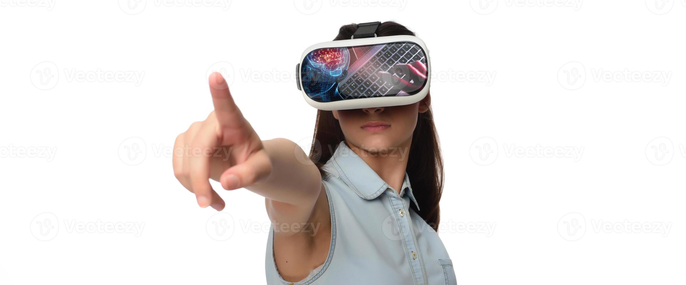 Pretty cute excited female in VR headset looking up and trying to touch objects in virtual reality photo