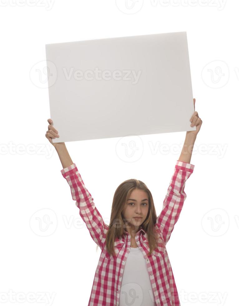 young smiling woman holding a blank sheet of paper for advertising photo