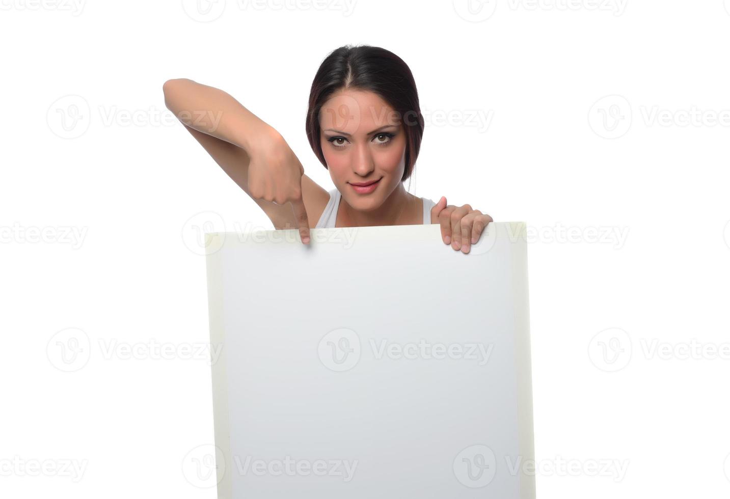 young smiling woman holding a blank sheet of paper for advertising photo