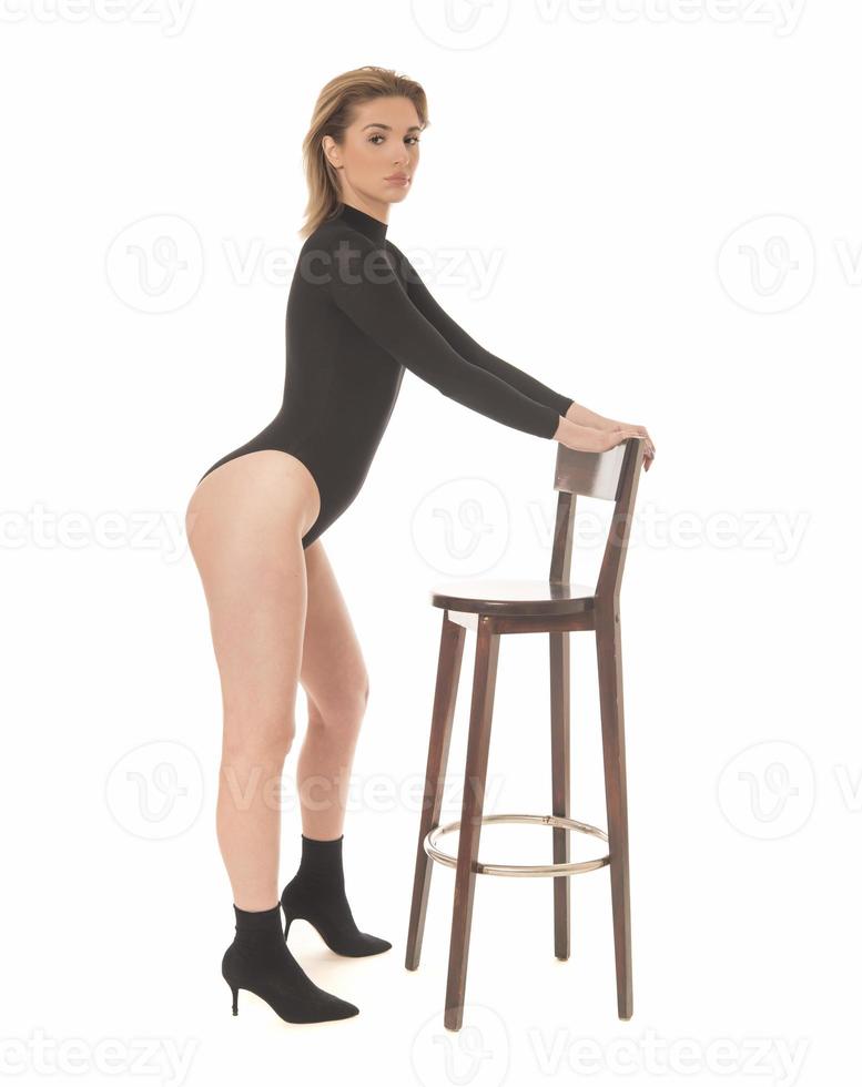 Fashionable young attractive woman posing in studio, wearing black sensual clothes photo