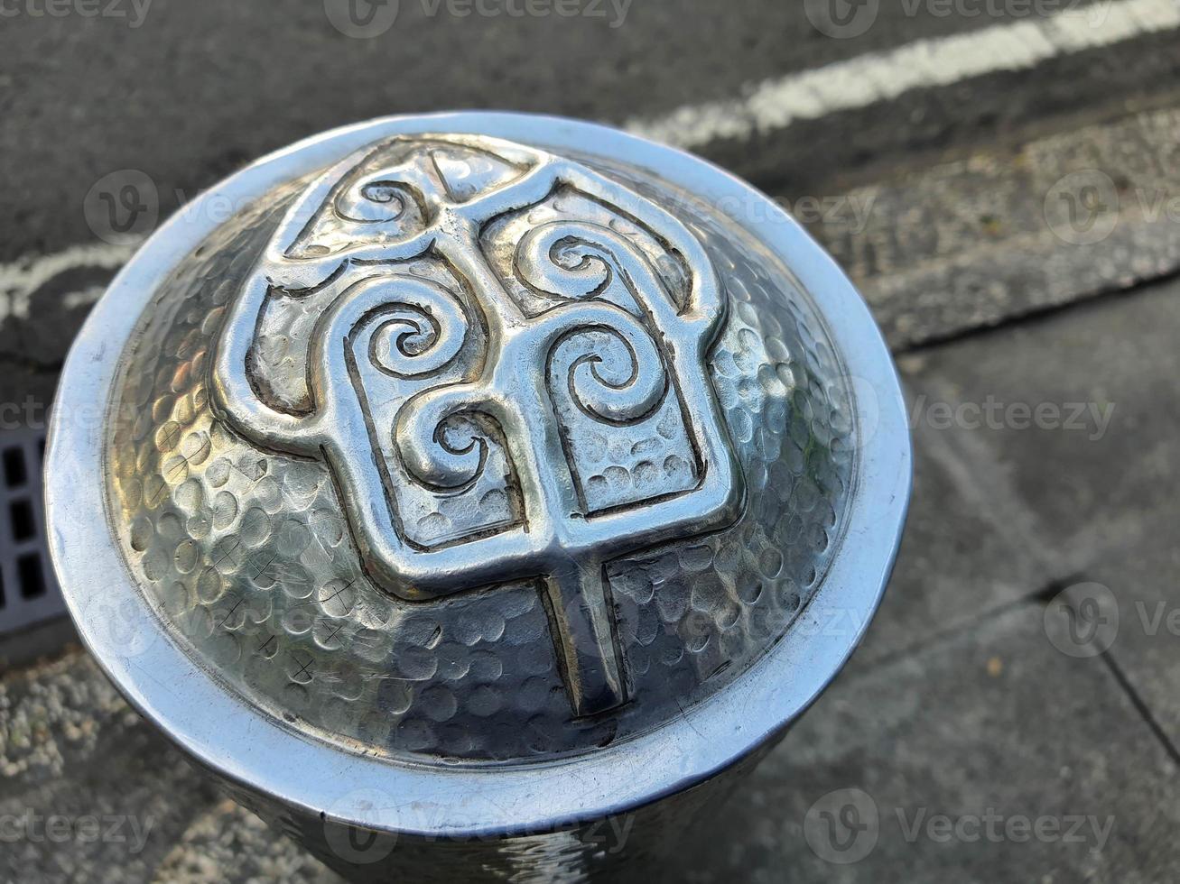 Pedestrian facilities on the Malioboro sidewalks include steel pipe bollards with traditional ornaments or motifs photo