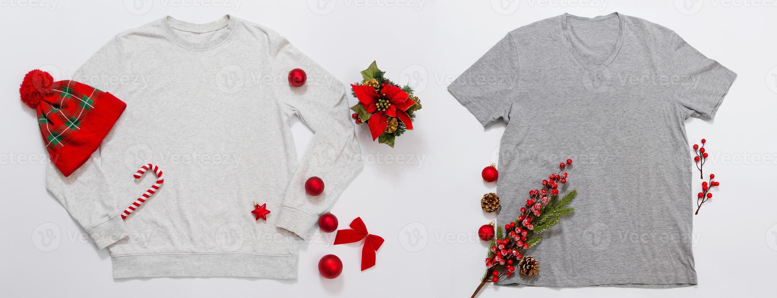 Close up banner grey blank template sweatshirt, t-shirt copy space. Christmas Holiday concept. Top view mockup hoodie shirt. Red holidays decorations on white background. Happy New Year accessories photo