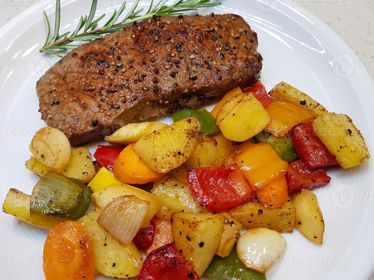 a freshly fried beef steak from the frying pan with delicious ingredients photo