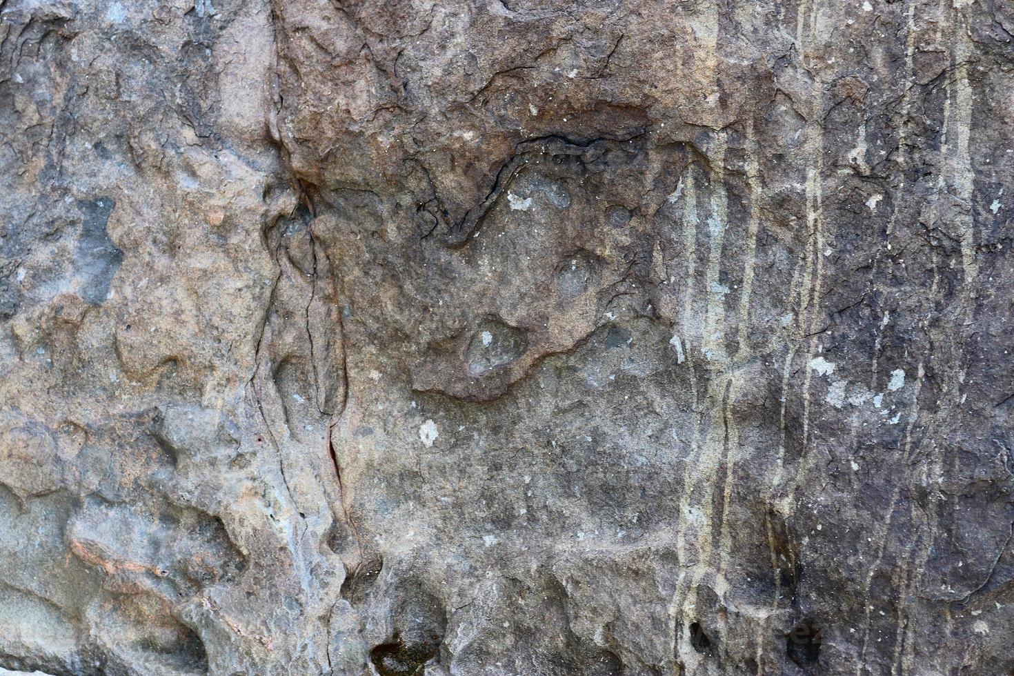 Close up view at a granite and stone wall texture in a high resolution. photo