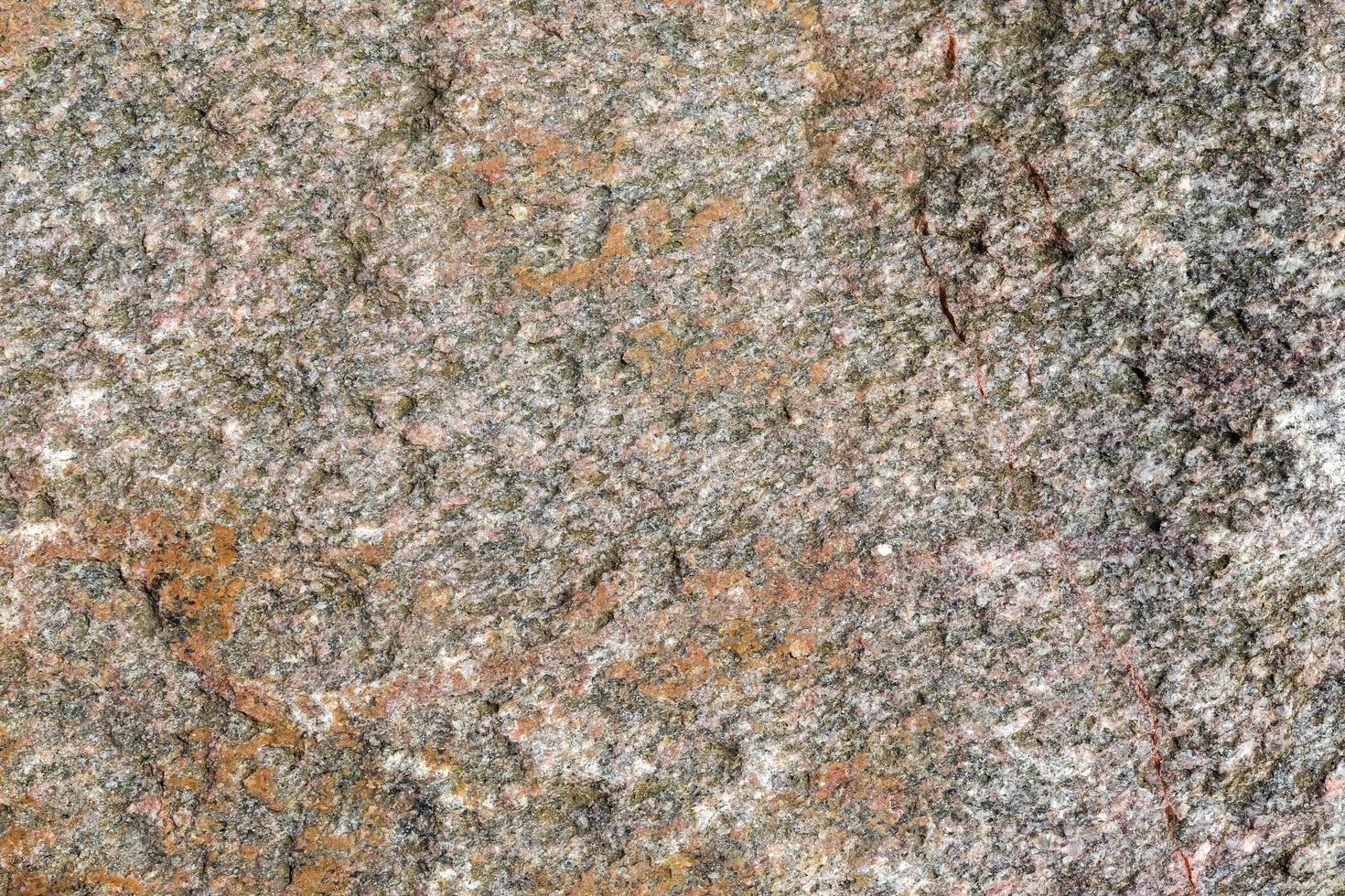 Close up view at a granite and stone wall texture in a high resolution. photo