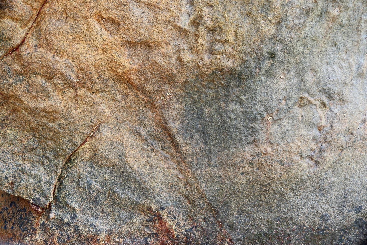 Close up view at a granite and stone wall texture in a high resolution. photo