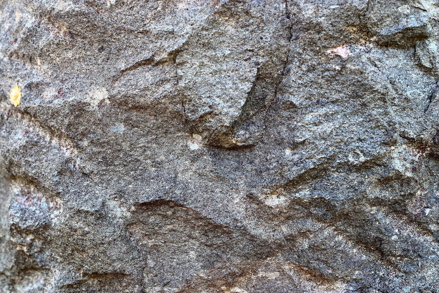 Close up view at a granite and stone wall texture in a high resolution. photo