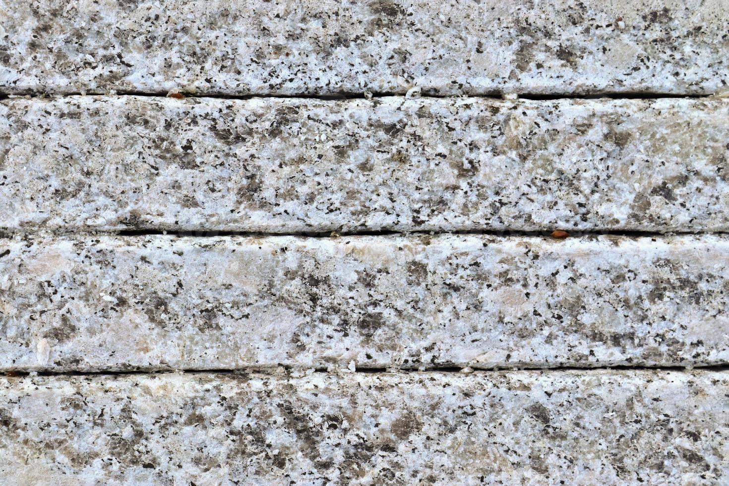 vista de cerca en una textura de pared de granito y piedra en alta resolución. foto