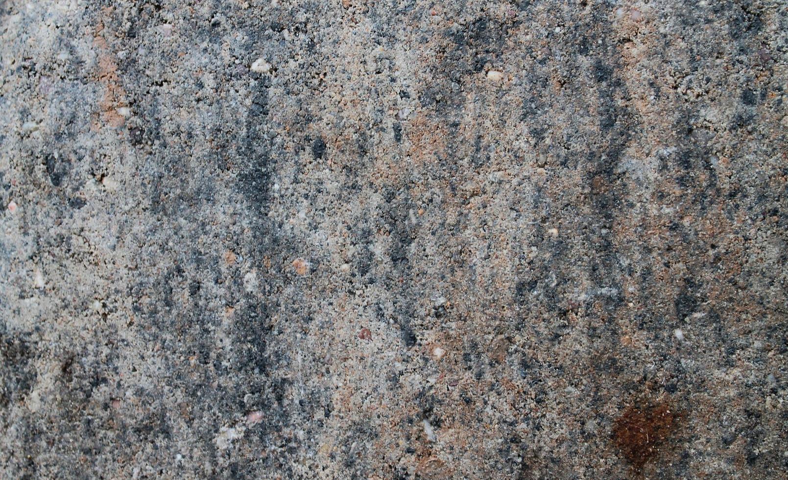 Close up view at a granite and stone wall texture in a high resolution. photo