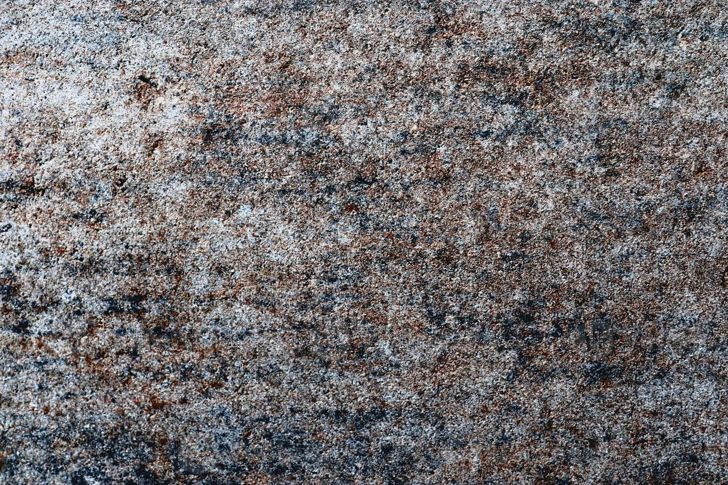 Close up view at a granite and stone wall texture in a high resolution. photo