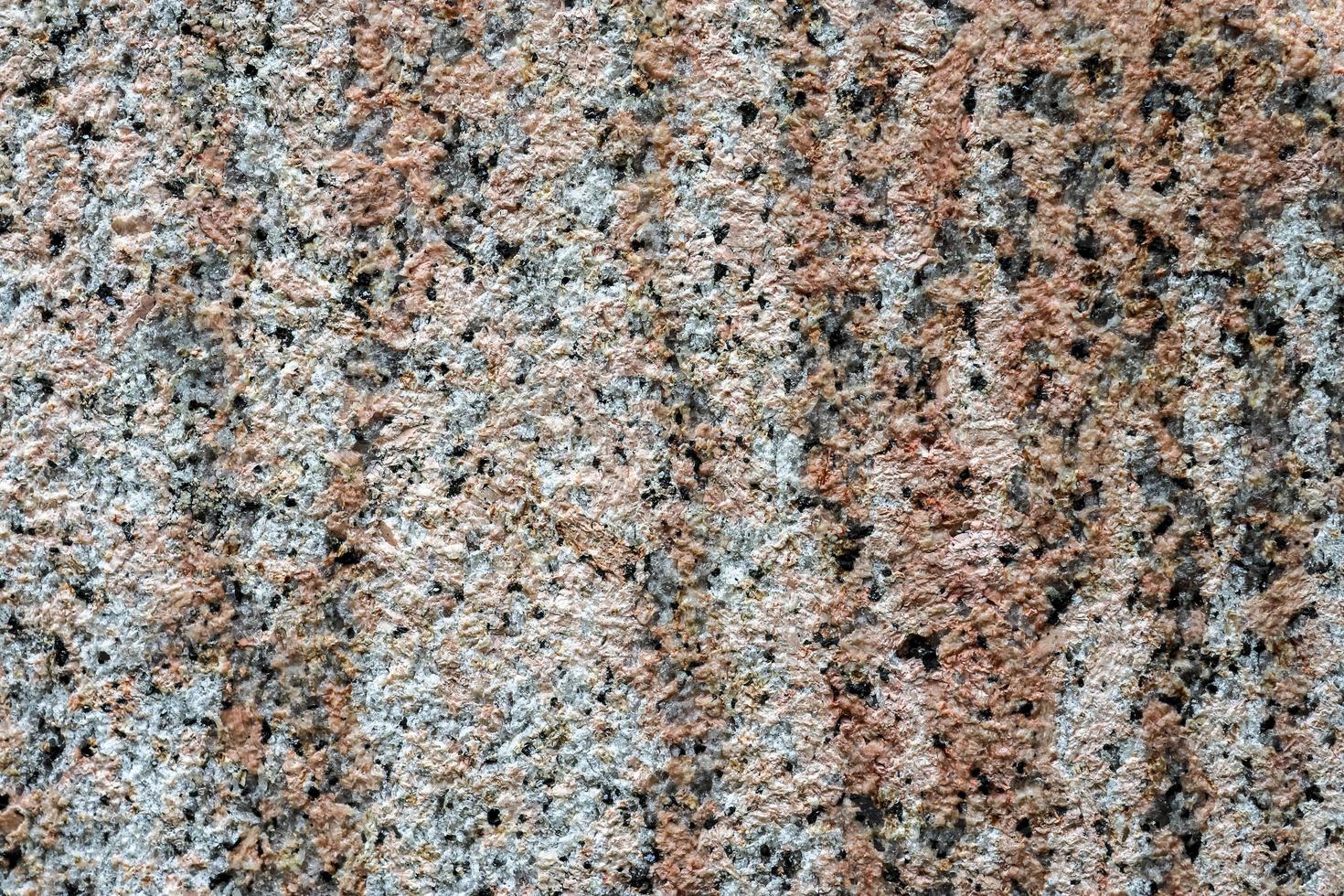 Granite stone wall texture in a detailed close up view in a high resolution. photo