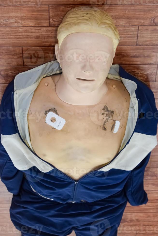 Human dummy lies on the floor during first Aid Training - Cardiopulmonary resuscitation. First aid course on CPR dummy, CPR First Aid Training Concept photo