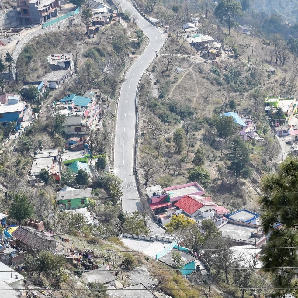 Aerial top view of traffic vehicles driving at mountains roads at Nainital, Uttarakhand, India, View from the top side of mountain for movement of traffic vehicles photo