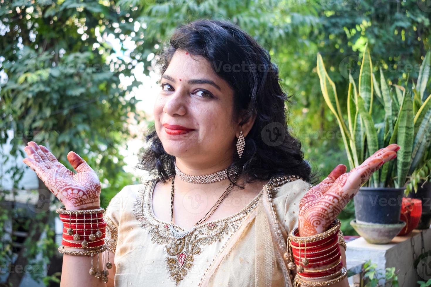 Beautiful woman dressed up as Indian tradition with henna mehndi design on her both hands to celebrate big festival of Karwa Chauth, Karwa Chauth celebrations by Indian woman for her husband photo