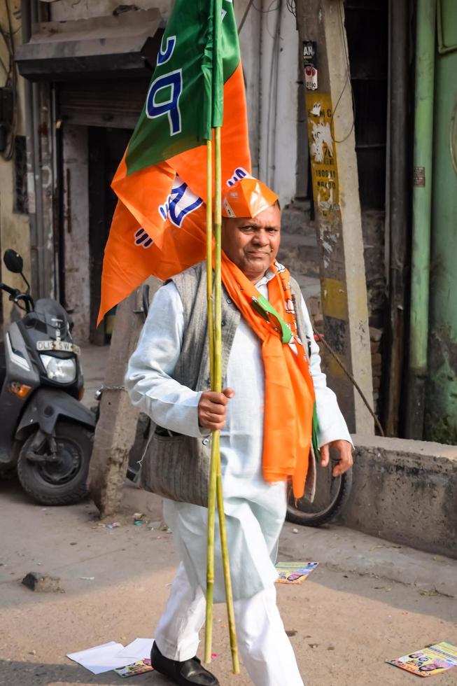 Delhi, India, December 02 2022  - Bharatiya Janata Party BJP supporter during mega road show in support of BJP candidate Pankaj Luthara to file nomination papers ahead of MCD local body Elections 2022 photo